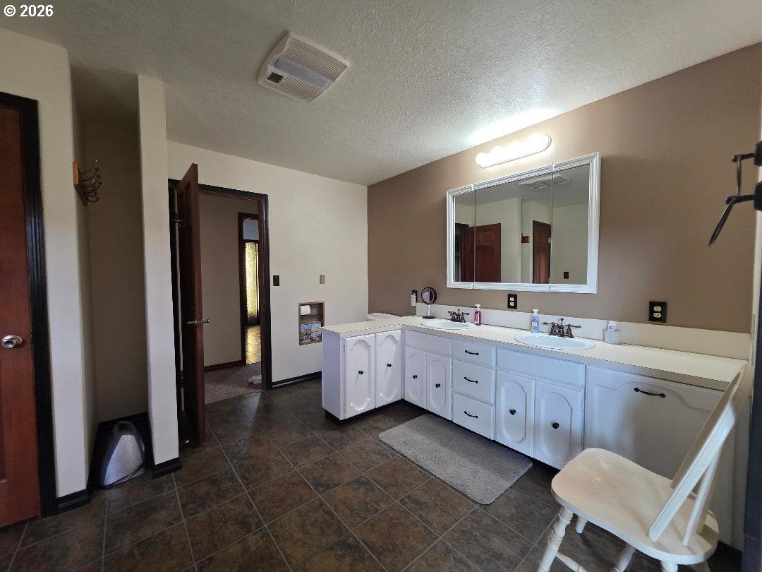 78902 Walters Road Maupin, OR 97037 - Photo 25 of 47 a large bathroom with a double vanity sink a mirror and a bathtub