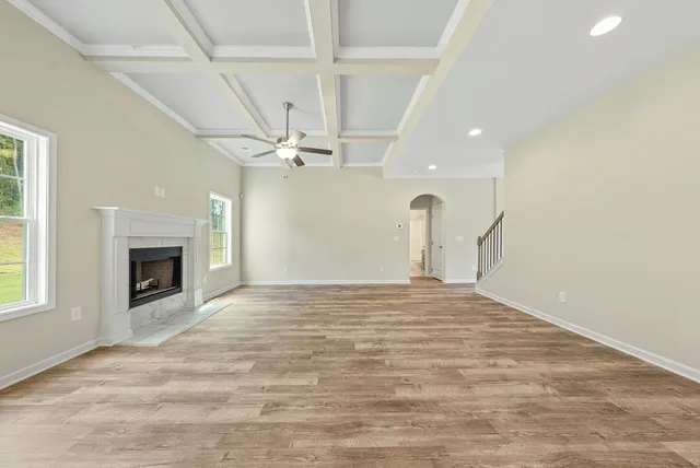 a view of an empty room with a fireplace and a window