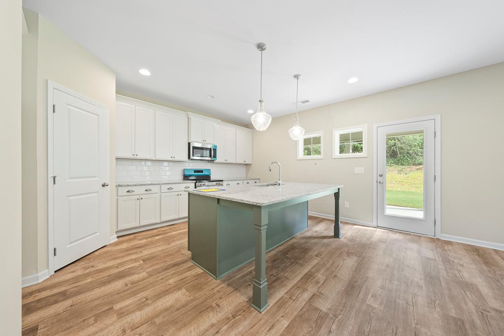 635 Bohannon Road Grantville, GA 30220 - Photo 13 of 43 a kitchen with a sink stove and cabinets