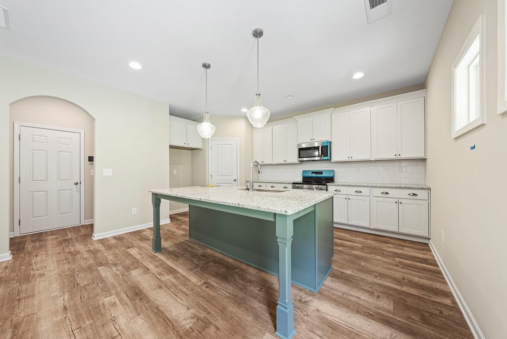 635 Bohannon Road Grantville, GA 30220 - Photo 15 of 43 a kitchen with kitchen island a sink stainless steel appliances and cabinets