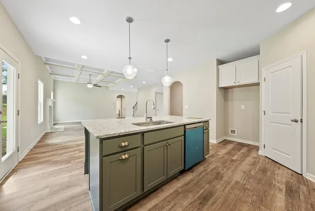 a kitchen with a sink a counter space and stainless steel appliances