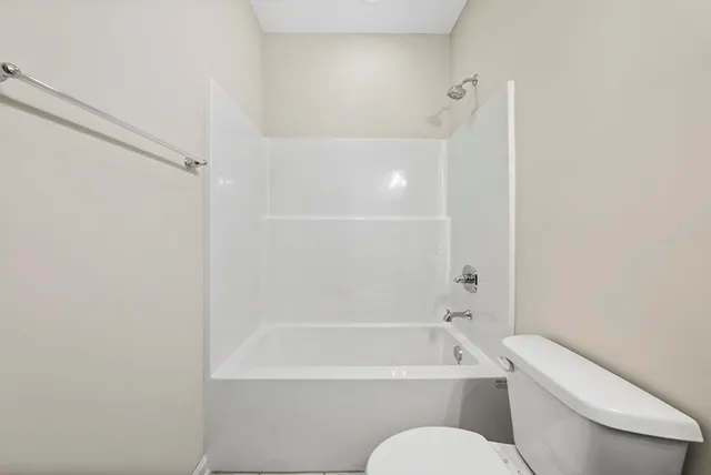 a bathroom with a toilet bathtub and shower