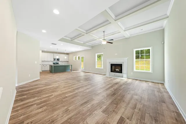an empty room with wooden floor and a window