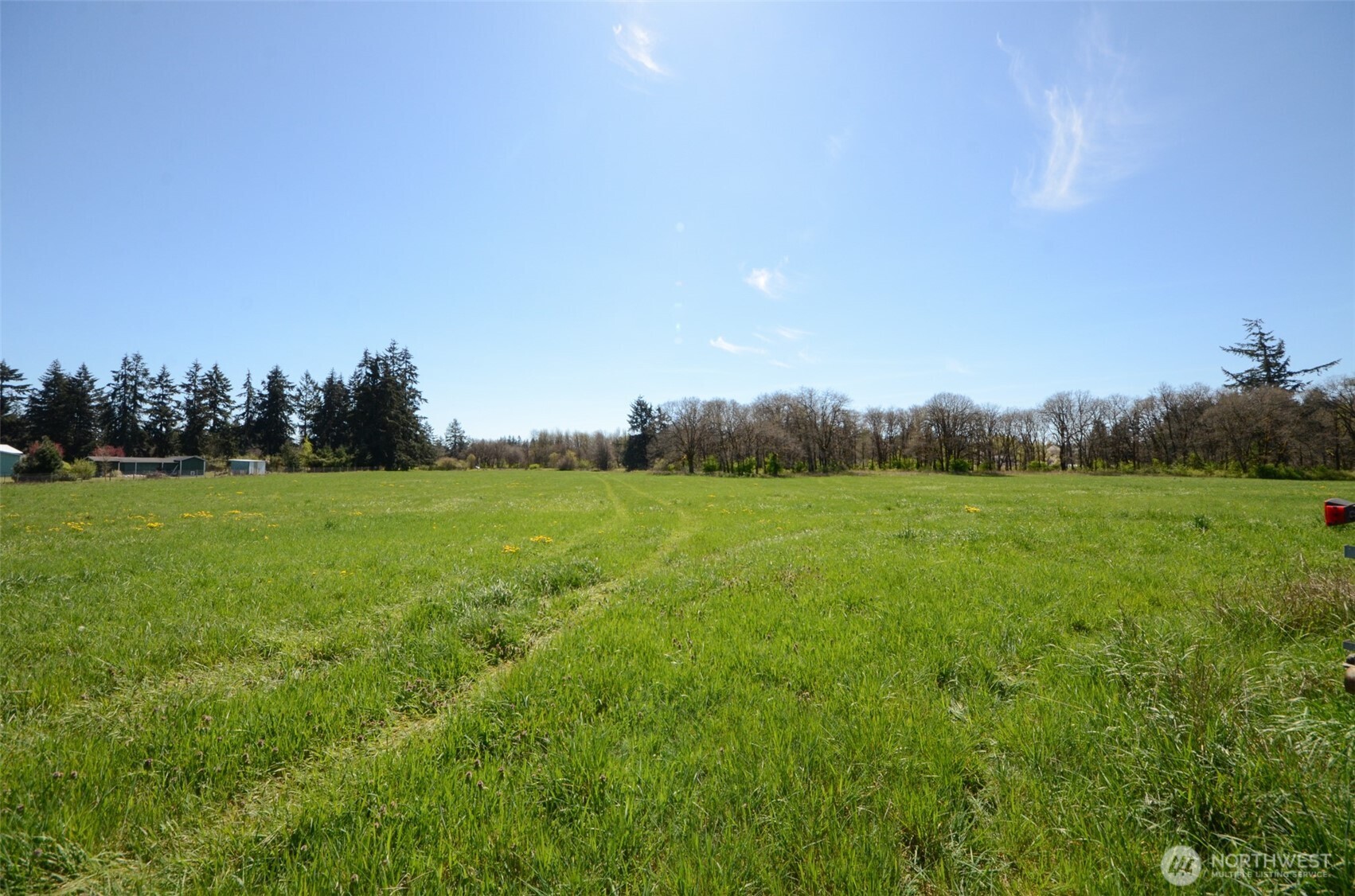 8941 183rd Avenue Southwest Rochester, WA 98579 - Photo 18 of 19 a view of a green field with wooden fence