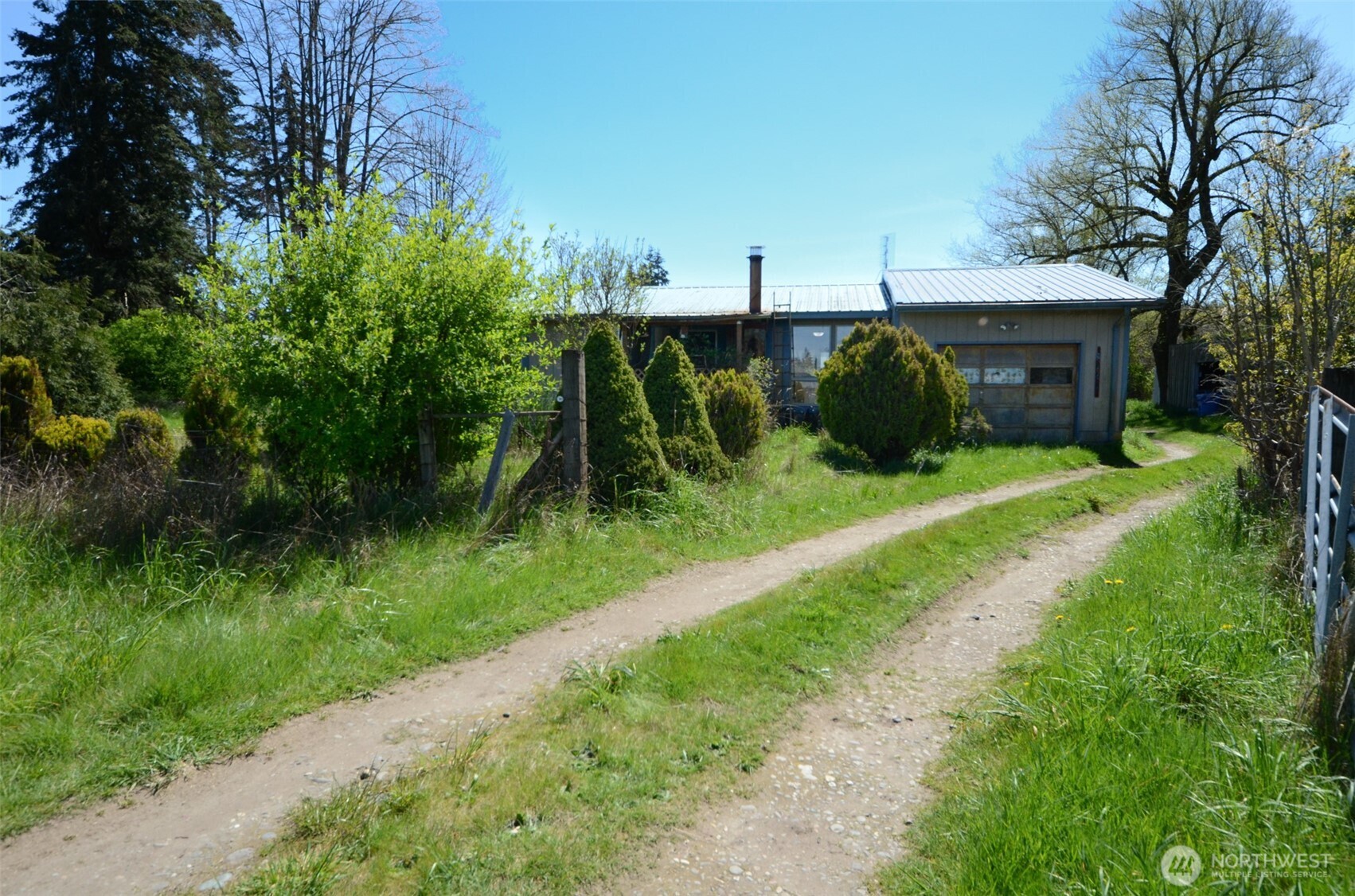 8941 183rd Avenue Southwest Rochester, WA 98579 - Photo 2 of 19 a view of a house with a yard and plants