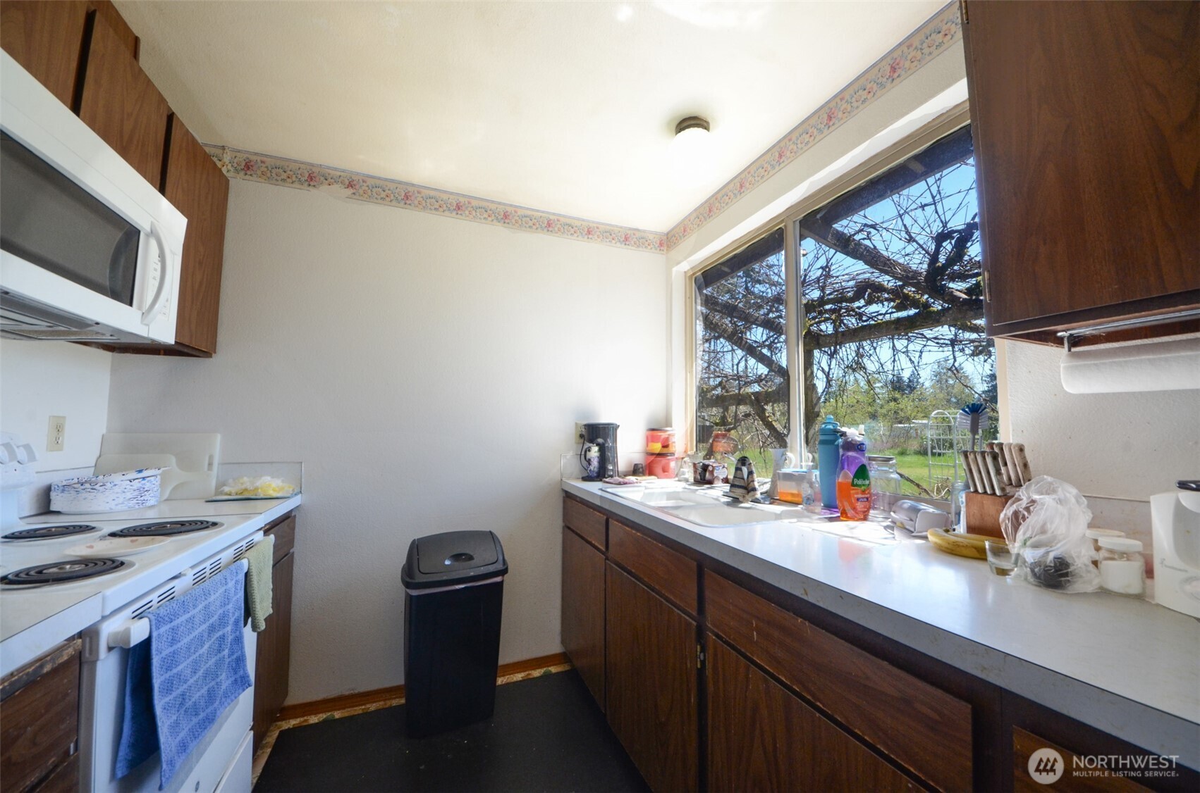 8941 183rd Avenue Southwest Rochester, WA 98579 - Photo 3 of 19 a kitchen with a sink cabinets and a window