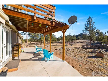 a patio with glass top table and chairs