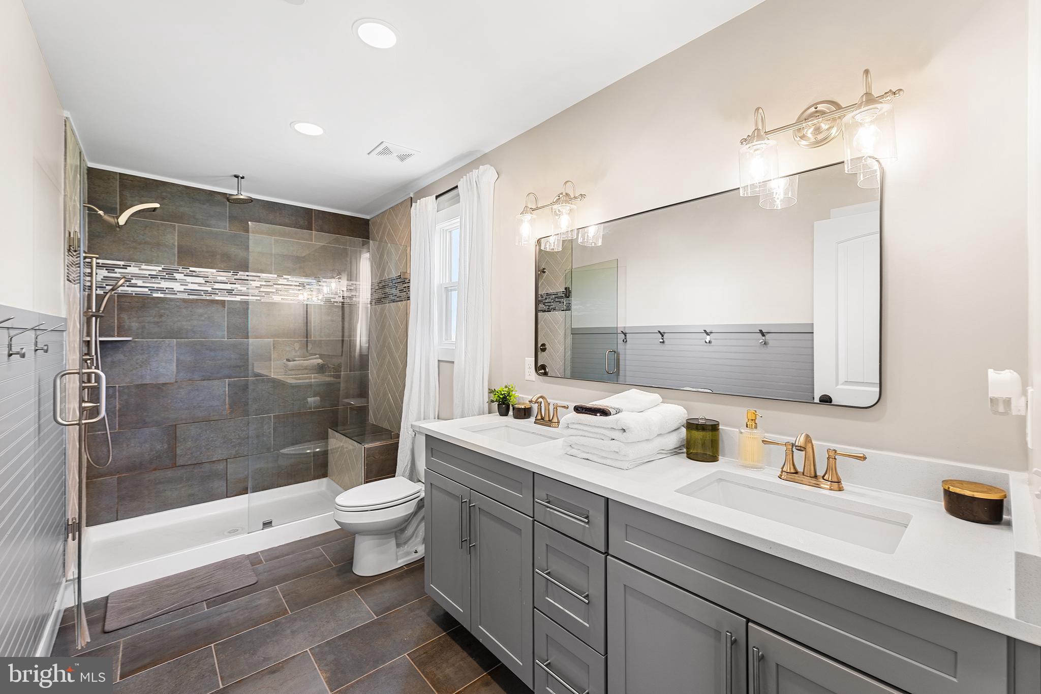 24766 Tribbett Circle Ridgely, MD 21660 - Photo 21 of 41 a bathroom with a double vanity sink toilet and shower