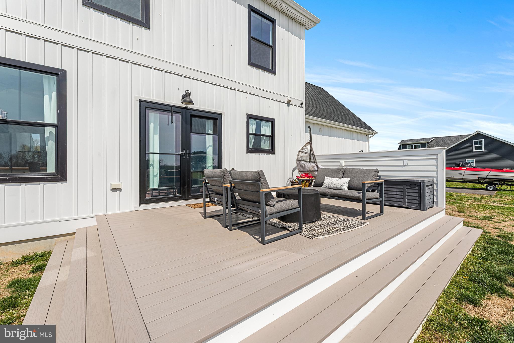 24766 Tribbett Circle Ridgely, MD 21660 - Photo 36 of 41 a view of a patio with table and chairs with wooden floor and fence