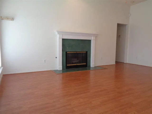 a view of empty room with a fireplace