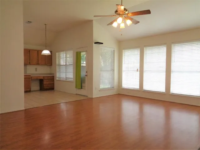 a view of a room with window and wooden floor