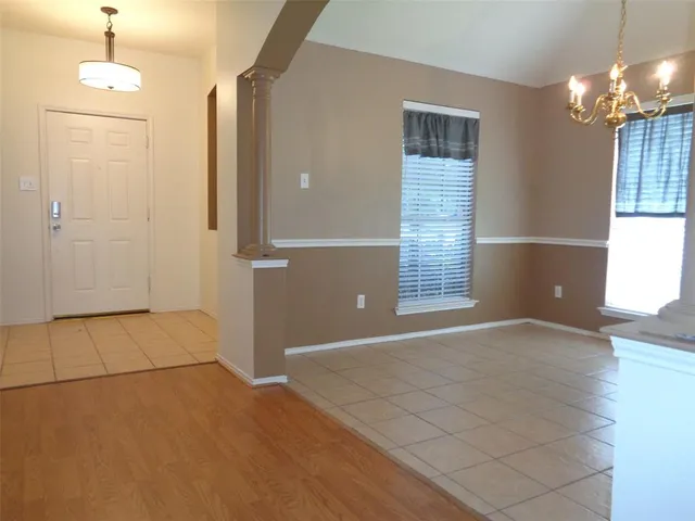 a view of a room with wooden floor and a bathroom