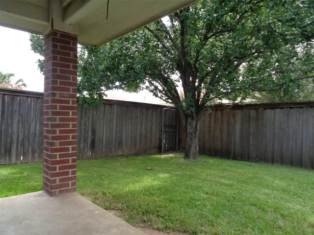 a front view of a house with a garden and yard