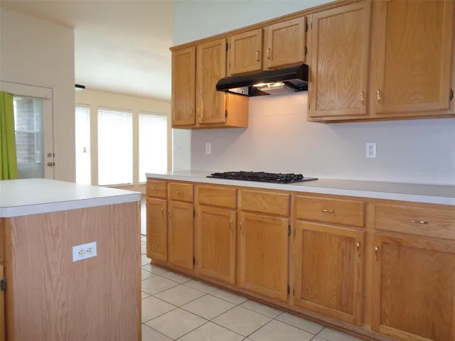 a kitchen with sink cabinets and window