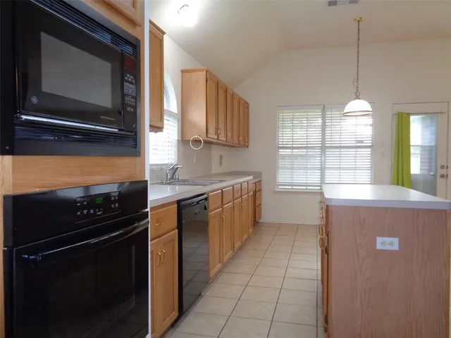 a kitchen with a stove and a microwave