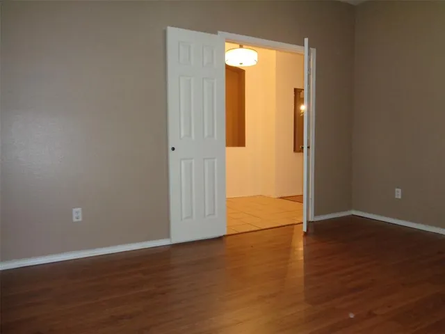an empty room with wooden floor