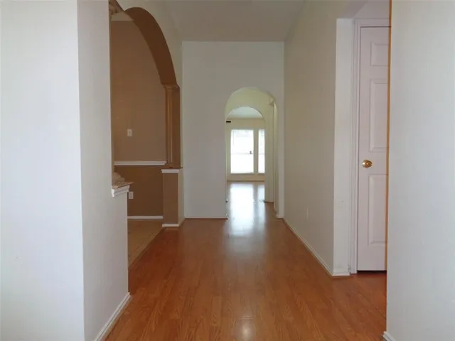 a view of hallway with wooden floor