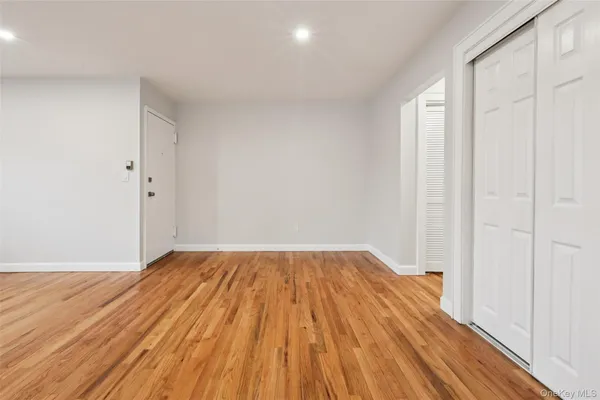 a view of a room with wooden floor