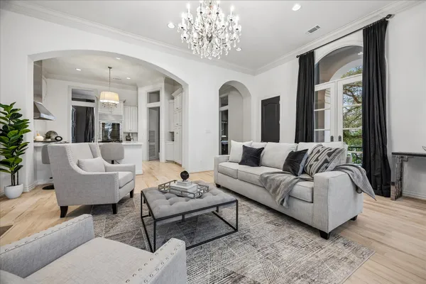 a living room with furniture and a chandelier