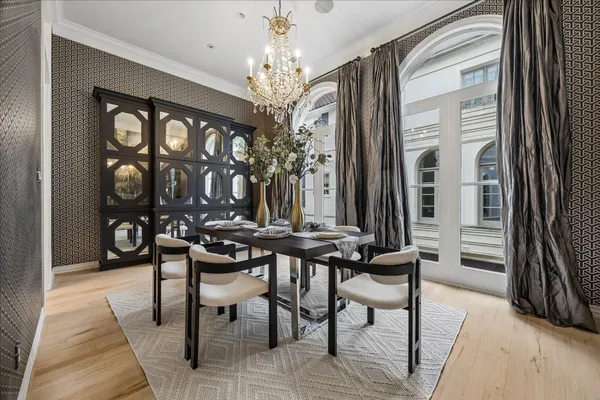 a view of a dining room with furniture and chandelier