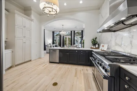 a kitchen with a stove and a wooden floors