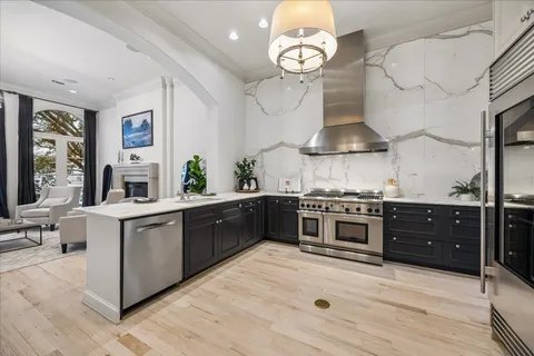 a kitchen with stainless steel appliances a stove and cabinets