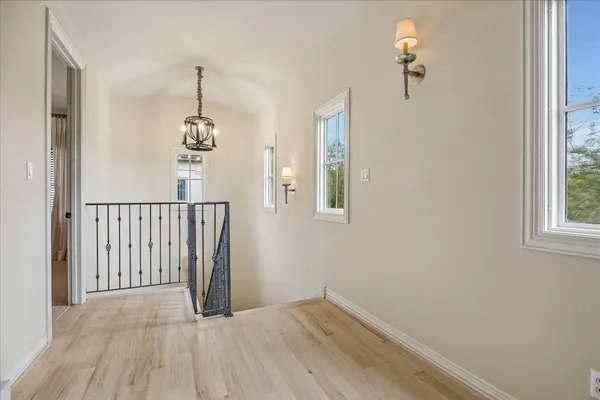 a view of a livingroom with wooden floor and a window