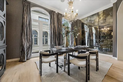 a view of a dining room with furniture and chandelier