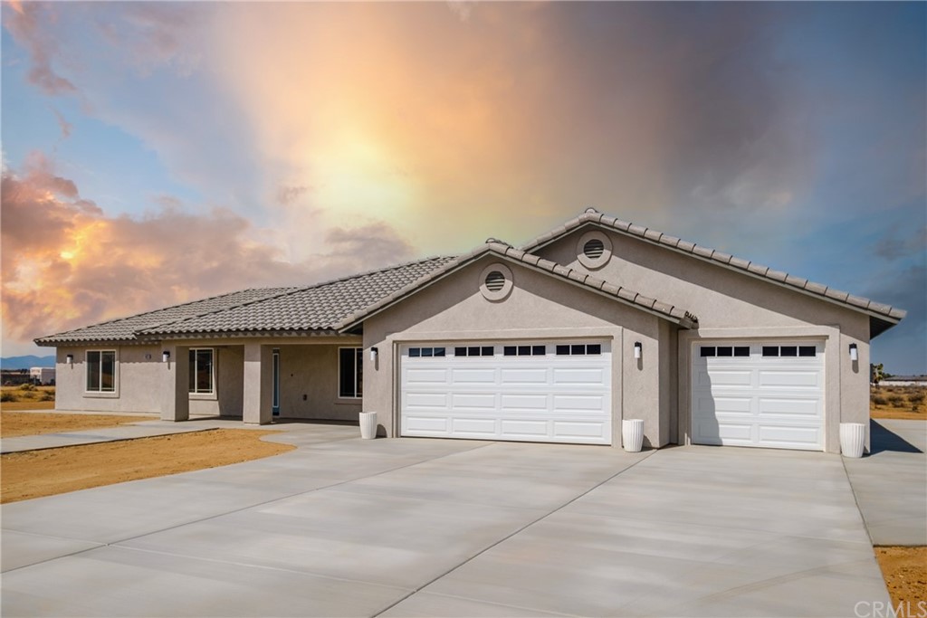 14820 Moccasin Road Apple Valley, CA 92307 - Photo 1 of 1 a front view of a house with a garage