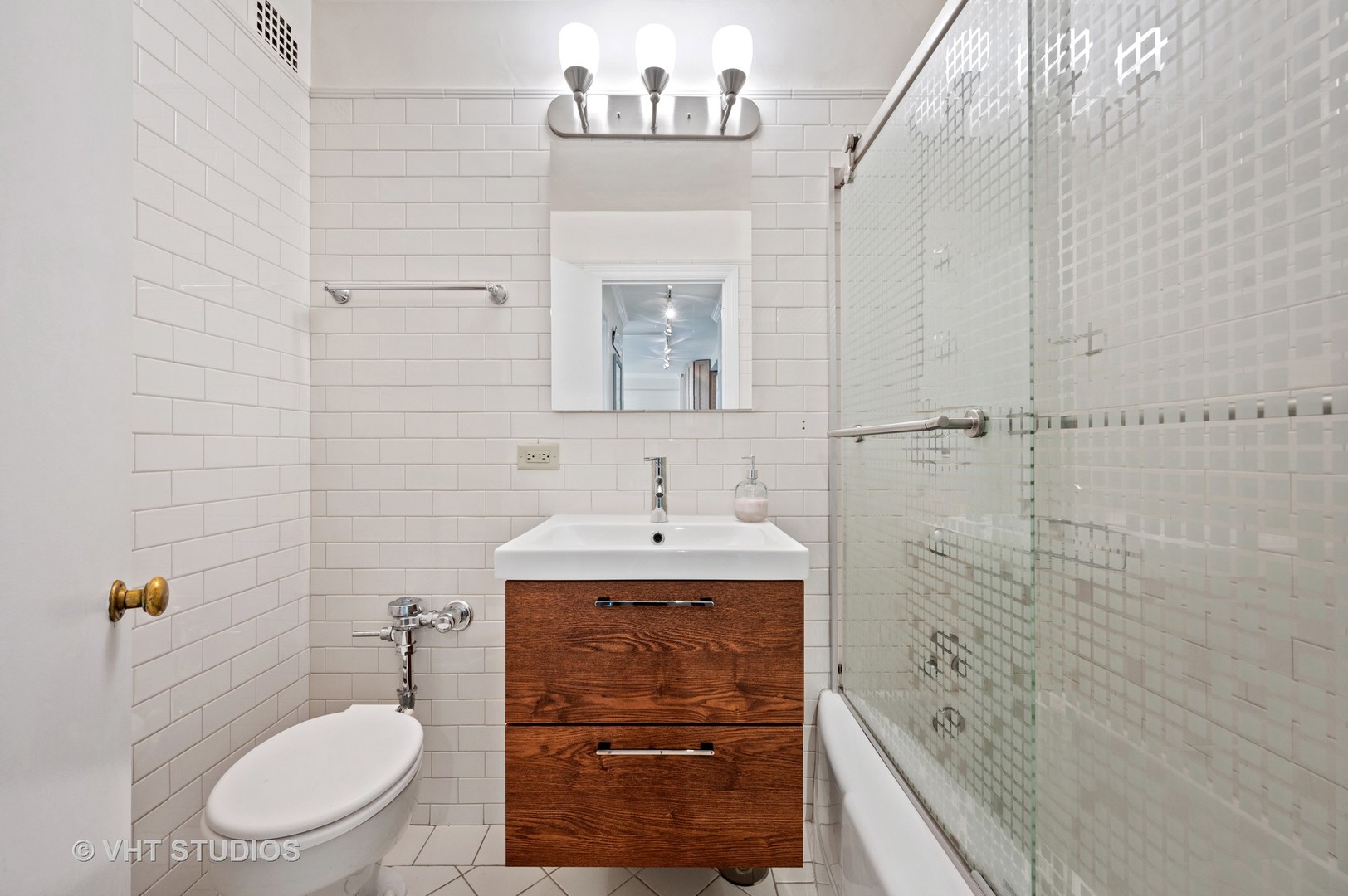 2909 North Sheridan Road, Unit 1105 Chicago, IL 60657 - Photo 10 of 11 a bathroom with a granite countertop sink a toilet and shower