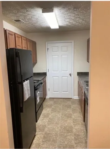 a kitchen with a refrigerator and washer