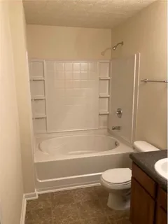 a bathroom with a toilet and a bath tub