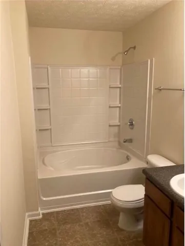 a bathroom with a toilet and a bath tub
