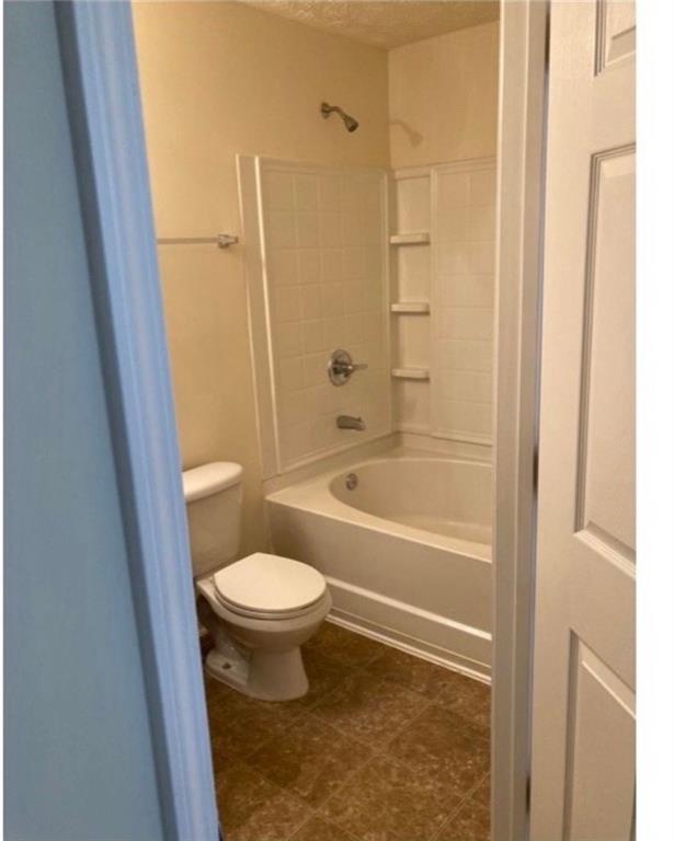 6102 Fairington Club Drive Lithonia, GA 30038 - Photo 10 of 12 a bathroom with a toilet and a shower