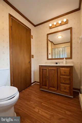 a bathroom with a toilet a sink and mirror