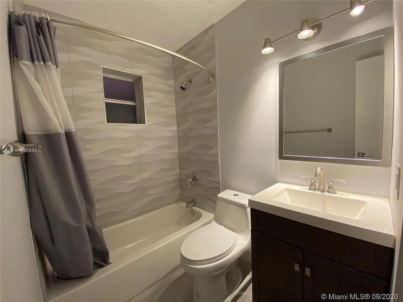 2633 Southwest 30th Court Miami, FL 33133 - Photo 19 of 24 a bathroom with a sink a toilet and shower