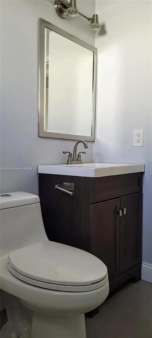 2633 Southwest 30th Court Miami, FL 33133 - Photo 23 of 24 a bathroom with a toilet sink and mirror