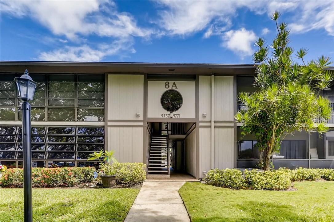 9763 West McNab Road, Unit 214 Tamarac, FL 33321 - Photo 1 of 28 a front view of a house with garden