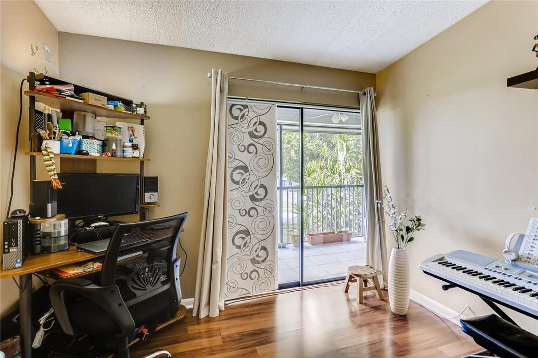 9763 West McNab Road, Unit 214 Tamarac, FL 33321 - Photo 16 of 28 a view of room with workspace and wooden floor