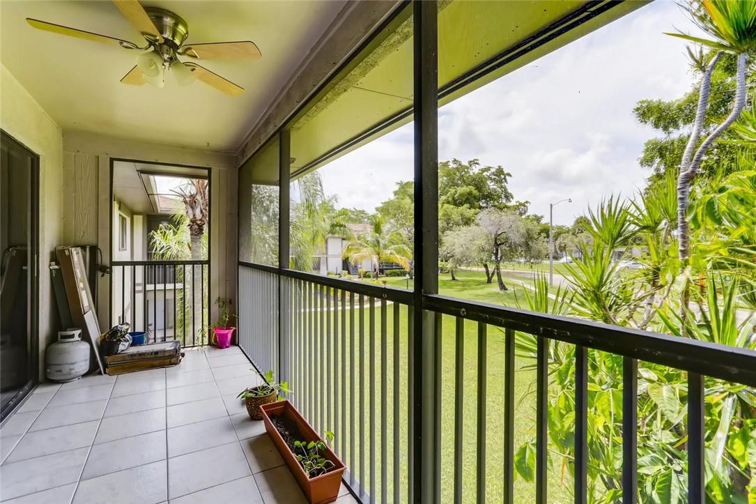 9763 West McNab Road, Unit 214 Tamarac, FL 33321 - Photo 23 of 28 a view of a porch with a floor to ceiling window