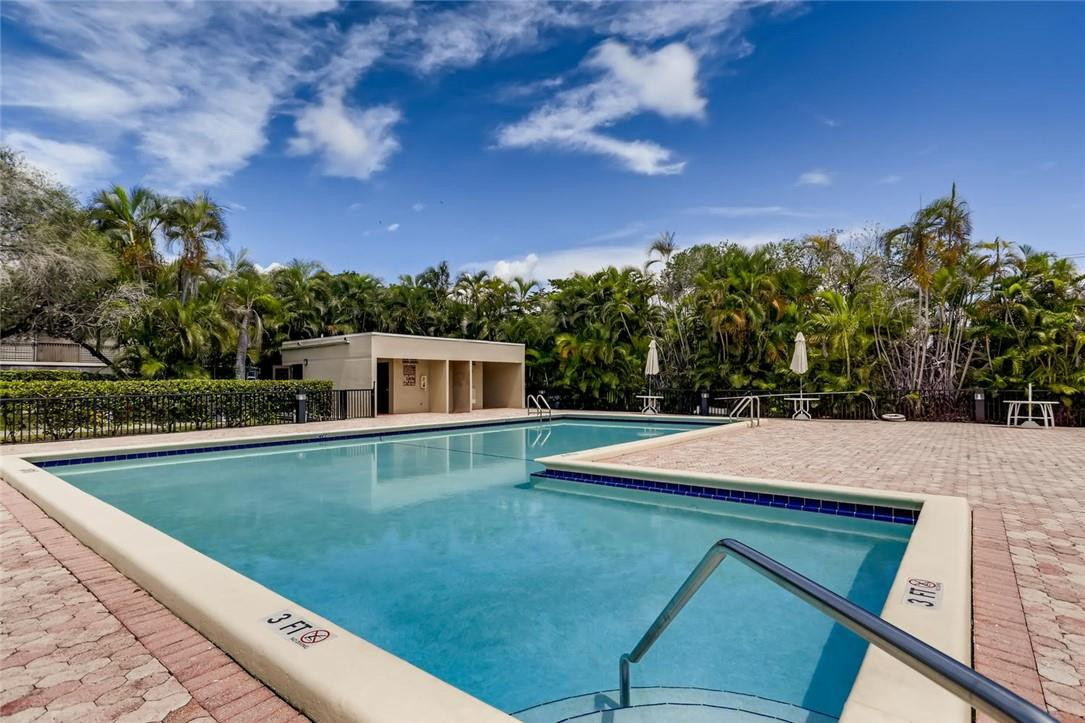 9763 West McNab Road, Unit 214 Tamarac, FL 33321 - Photo 26 of 28 a view of a swimming pool with a yard