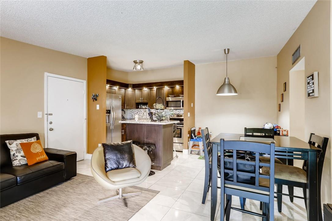 9763 West McNab Road, Unit 214 Tamarac, FL 33321 - Photo 3 of 28 a living room with furniture and a fireplace