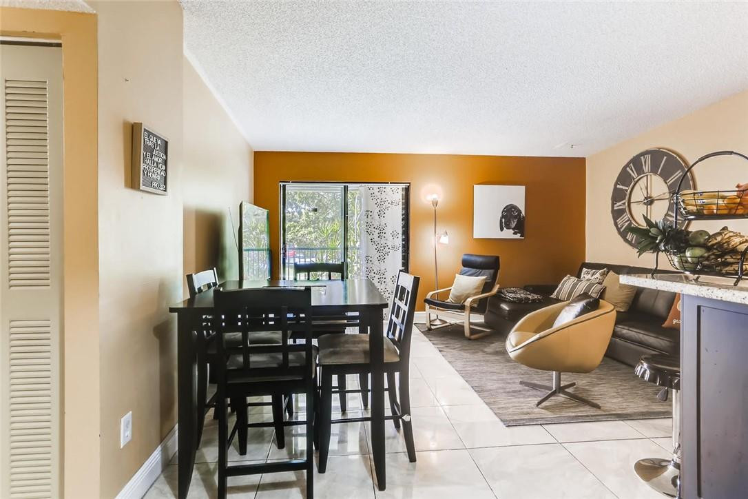 9763 West McNab Road, Unit 214 Tamarac, FL 33321 - Photo 5 of 28 a living room with furniture a window and a table