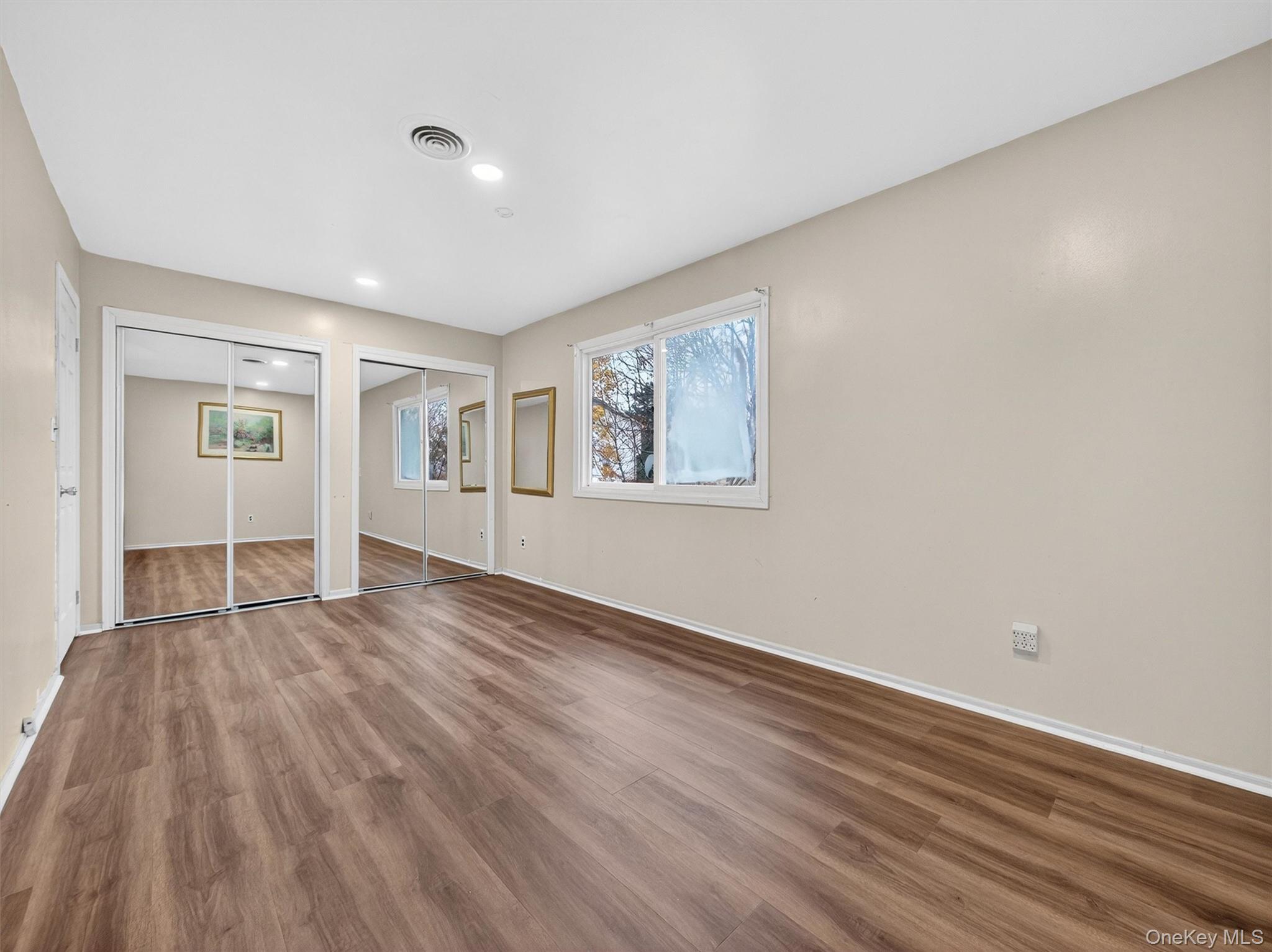 69 Gerow Avenue Spring Valley, NY 10977 - Photo 11 of 18 a view of an empty room with wooden floor and a window