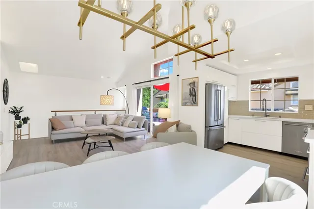 a living room with furniture and kitchen view