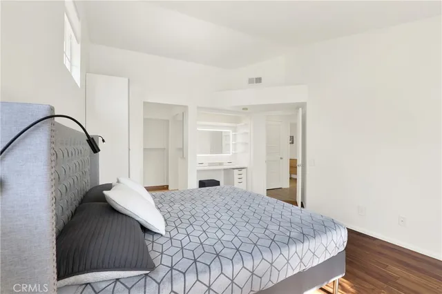 a bedroom with a bed and a mirror