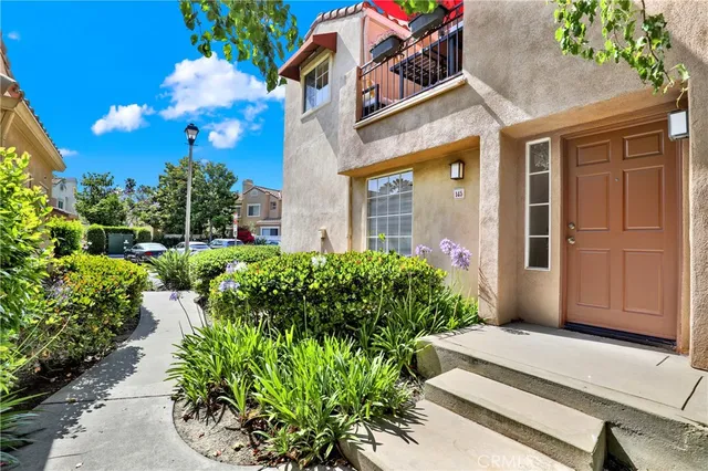 a front view of a house with a yard and flowers
