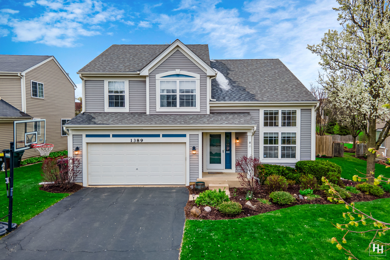 1389 Collins Drive Cary, IL 60013 - Photo 1 of 39 a front view of a house with a garden and plants