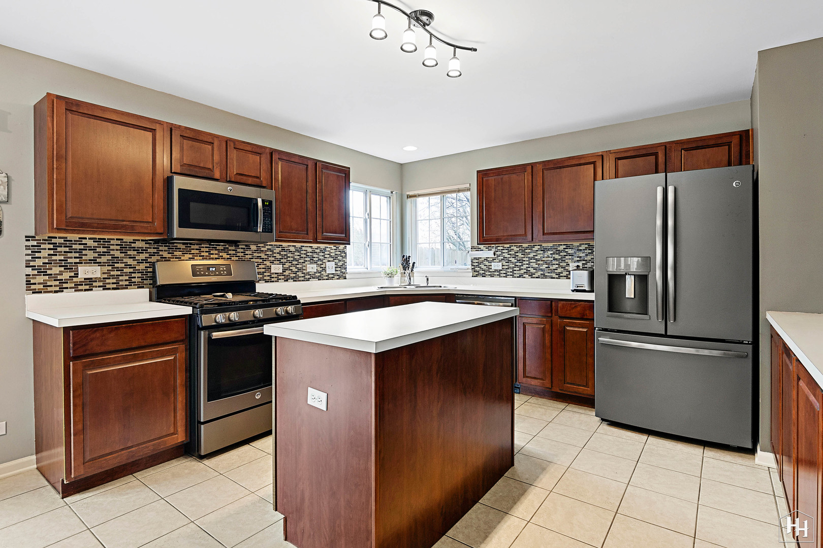 1389 Collins Drive Cary, IL 60013 - Photo 11 of 39 a kitchen with stainless steel appliances granite countertop a refrigerator stove microwave and sink