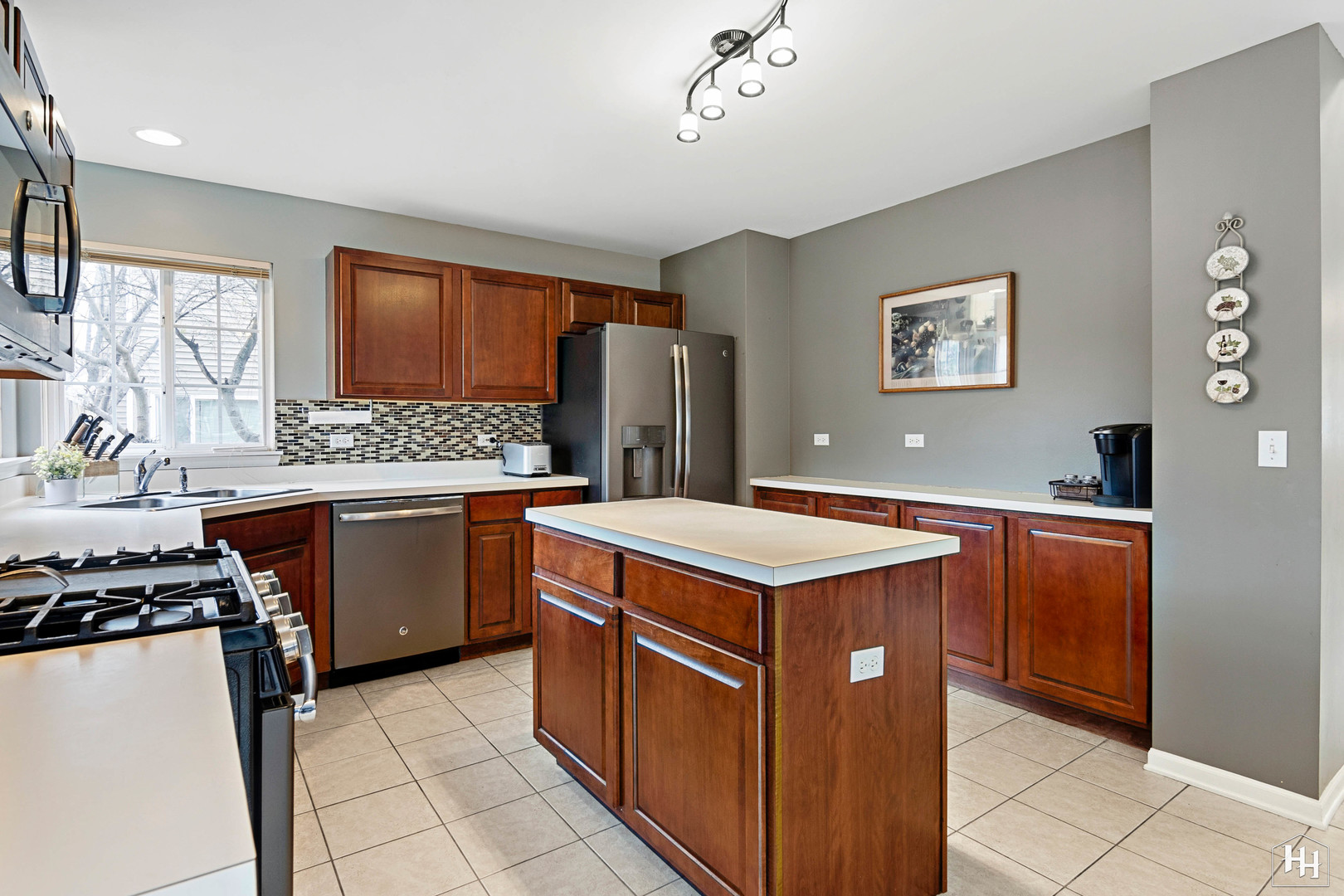 1389 Collins Drive Cary, IL 60013 - Photo 12 of 39 a kitchen with stainless steel appliances granite countertop a stove top oven sink and cabinets